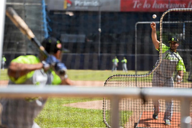 Players of the Venezuelan baseball team Leones del Caracas attend a training session at the Universitario stadium in Caracas, on September 18, 2017. While baseball is Venezuela's national sport, some fans are angry that the government, given the severity of the economic crisis and the political tension, will spend nearly ten million dollars on organizing the upcoming Winter League rather than on imports of food and medicine. / AFP PHOTO / FEDERICO PARRA