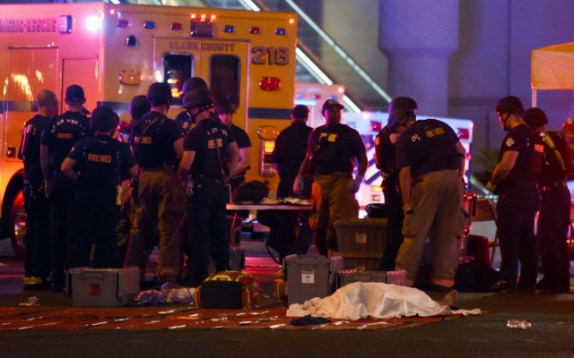 LAS VEGAS, NV - OCTOBER 01: A body lies under a sheet as fire and rescue personnel gather at the intersection of Las Vegas Boulevard and Tropicana Ave. after a mass shooting at a country music festival nearby on October 1, 2017 in Las Vegas, Nevada. A gunman has opened fire on a music festival in Las Vegas, leaving at least 20 people dead and more than 100 injured. Police have confirmed that one suspect has been shot. The investigation is ongoing. Ethan Miller/Getty Images/AFP