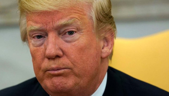 U.S. President Donald Trump looks up as reporters ask questions about the future of U.S. Secretary of State Rex Tillerson in the Oval Office at the White House in Washington, U.S., November 30, 2017.  REUTERS/Kevin Lamarque