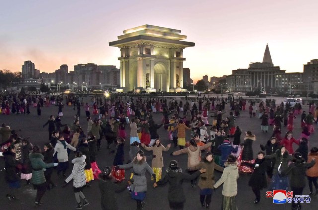 People dance on a square in Pyongyang, North Korea in this undated photo released by North Korea's Korean Central News Agency (KCNA) November 30, 2017. REUTERS/KCNA ATTENTION EDITORS - THIS IMAGE WAS PROVIDED BY A THIRD PARTY. REUTERS IS UNABLE TO INDEPENDENTLY VERIFY THIS IMAGE. NO THIRD PARTY SALES. SOUTH KOREA OUT. NO COMMERCIAL OR EDITORIAL SALES IN SOUTH KOREA