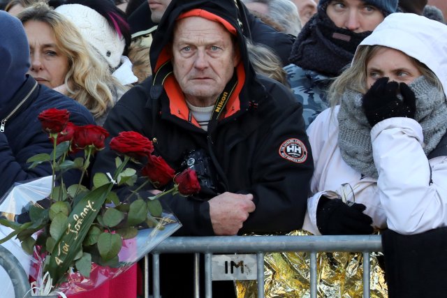 Fans gather outside the Madeleine Church to attend a ceremony during a 'popular tribute' to late French singer and actor Johnny Hallyday in Paris, France, December 9, 2017. REUTERS/Ludovic Marin/Pool