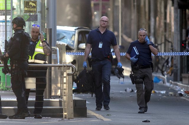 Australian police is seen near the place where they arrested the driver of a vehicle that had ploughed into pedestrians at a crowded intersection near the Flinders Street train station, in central Melbourne, Australia, December 21, 2017. REUTERS/Luis Ascui