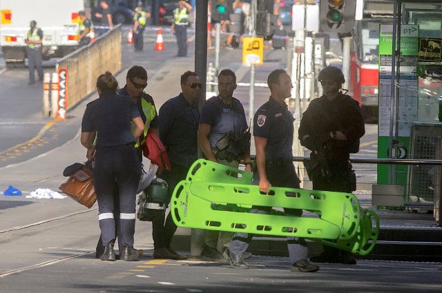 Australian police and paramedics are seen near the place where they arrested the driver of a vehicle that had ploughed into pedestrians at a crowded intersection near the Flinders Street train station, in central Melbourne, Australia, December 21, 2017. REUTERS/Luis Ascui