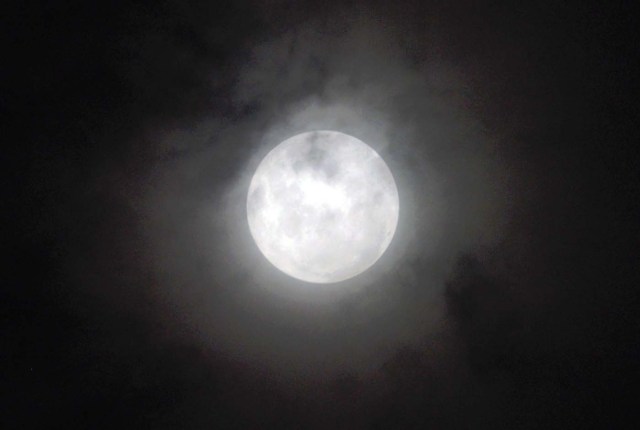 The 'supermoon' is pictured rising over Asuncion on January 1, 2018. Supermoons happen when a full moon approximately coincides with the moon's perigee, or a point in its orbit at which it is closest to Earth. / AFP PHOTO / NORBERTO DUARTE