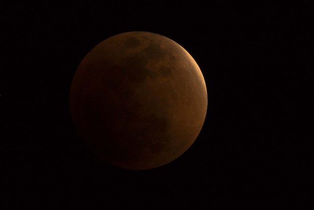 The moon is seen during a lunar eclipse, referred to as the "super blue blood moon", in Beijing on January 31, 2018. Skywatchers were hoping for a rare lunar eclipse that combines three unusual events -- a blue moon, a super moon and a total eclipse -- which was to make for a large crimson moon viewable in many corners of the globe. / AFP PHOTO / NICOLAS ASFOURI