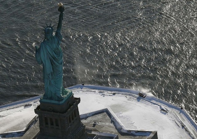 NEW YORK, NY - JANUARY 05: A snow plows Liberty Island next to the Statue of Liberty on January 5, 2018 in New York City. New York City dug out from the "Bomb Cyclone" under frigid temperatures. John Moore/Getty Images/AFP