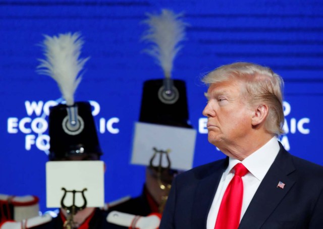 U.S. President Donald Trump listens to concert and marching band Landwehr de Fribourg, during the World Economic Forum (WEF) annual meeting in Davos, Switzerland January 26, 2018. REUTERS/Denis Balibouse