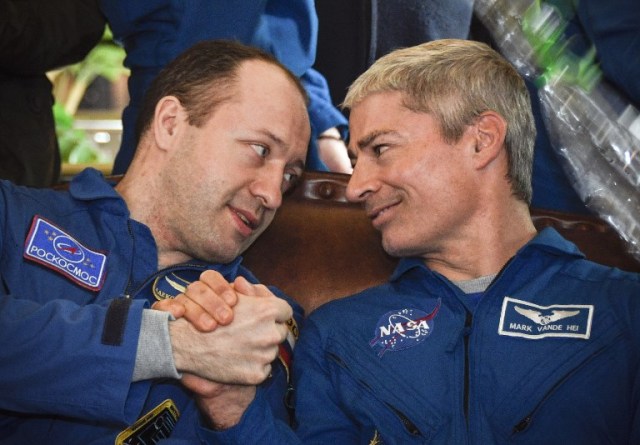 El cosmonauta ruso Alexander Misurkin (izq.) De Roscosmos estrecha la mano del astronauta estadounidense Mark Vande Hei de la NASA durante una conferencia de prensa en Dzhezkazgan el 28 de febrero de 2018. / AFP PHOTO / POOL / Alexander NEMENOV