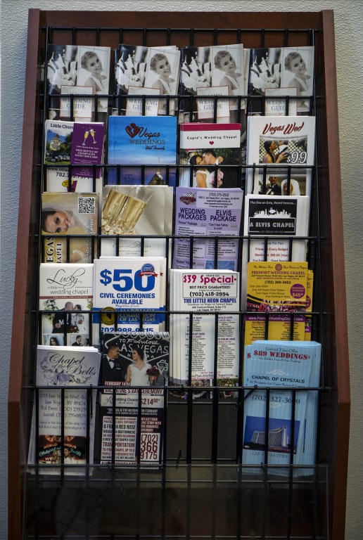 Wedding chapel and marriage pamphlets are available as the Clark County Clerk's Office operates a temporary pop-up marriage license office at McCarran International Airport in Las Vegas on February 12, 2018. The Las Vegas airport has given new meaning to rushing to make a connection, offering quickie wedding licenses for lovebirds desperate to get hitched on Valentine's Day. Clark County, the authority that administers Sin City's weddings, has opened a pop-up marriage license bureau by a baggage carousel at McCarran International Airport. / AFP PHOTO / L.E. Baskow / TO GO WITH AFP STORY, "Valentines get quickie marriage licenses at Las Vegas airport"