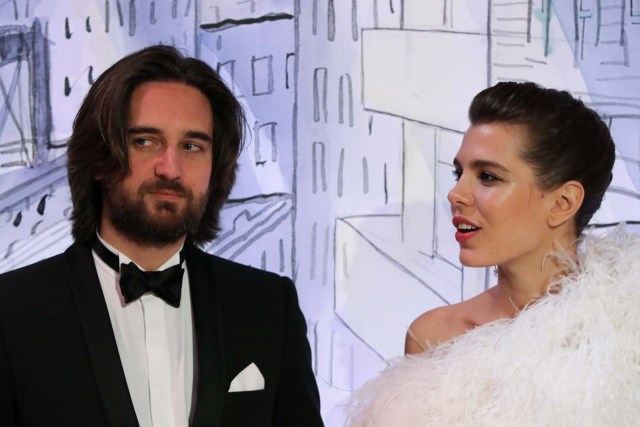 Charlotte Casiraghi (R) and her partner Dimitri Rassam (L) pose upon their arrival for the annual Rose Ball at the Monte-Carlo Sporting Club in Monaco, on March 24, 2018. The Rose Ball is one of the major charity events in Monaco. Created in 1954, it benefits the Princess Grace Foundation. / AFP PHOTO / POOL / VALERY HACHE