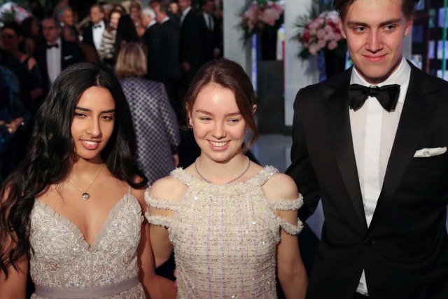 Princess Alexandra of Hanover (C) and her companion Ben-Sylvester Strautmann (R) arrive for the annual Rose Ball at the Monte-Carlo Sporting Club in Monaco, on March 24, 2018. The Rose Ball is one of the major charity events in Monaco. Created in 1954, it benefits the Princess Grace Foundation. / AFP PHOTO / POOL / VALERY HACHE