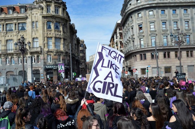 A protester holds a banner reading "Fight Like A Girl" during a demonstration for women's rights on International Women's Day in Bilbao, Spain March 8, 2018. REUTERS/Vincent West