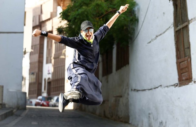 Saudi woman Nouf Khayat, a Zumba instructor, jumps during a running event marking International Women's Day in Old Jeddah, Saudi Arabia March 8, 2018. "I am a mother and a woman in this society. Finally we are capable of speaking up and of expressing our passions. The time has come to speak about the things that we can do," she said. REUTERS/Faisal Al Nasser