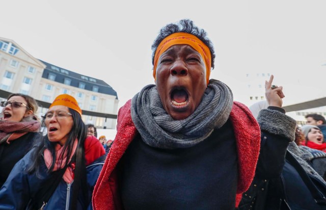 Women's rights activists shout during a gathering on the street on the International Women's Day in Brussels, Belgium March 8, 2018. REUTERS/Yves Herman