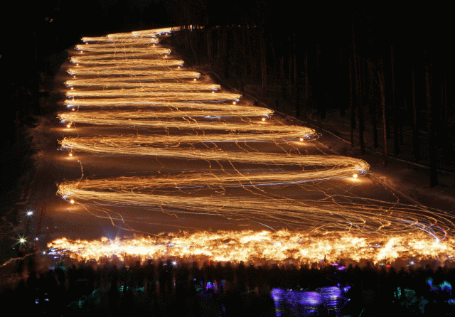 Los esquiadores y practicantes de snowboard descienden de una pendiente durante un festival anual en Zheleznogorsk. REUTERS/ Ilya Naymushin