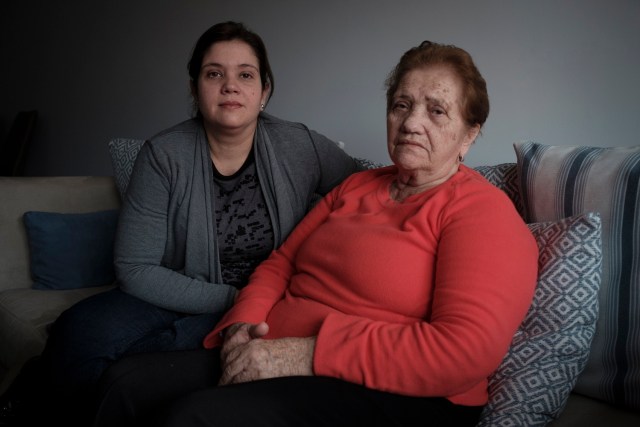 Venezuelan Susana (L) and her mother (no name given) pose in Vigo, northwestern Spain, on March 14, 2018. Decades ago, they left their homes in northwestern Spain in their thousands for Venezuela, fleeing poverty or attracted by promises of oil riches. Now, many are coming back to Galicia -- or at least their descendants are -- escaping an acute crisis in Venezuela for the remote Spanish region, lured by authorities there who want to attract younger people, faced as they are with an ageing population. / AFP PHOTO / Miguel Riopa