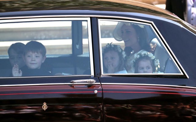 Britain's Catherine, Duchess of Cambridge and Prince Harry's niece and bridesmaid Princess Charlotte (R) arrive for the wedding ceremony of Britain's Prince Harry, Duke of Sussex and US actress Meghan Markle at St George's Chapel, Windsor Castle, in Windsor, on May 19, 2018. / AFP PHOTO / POOL / Jane Barlow